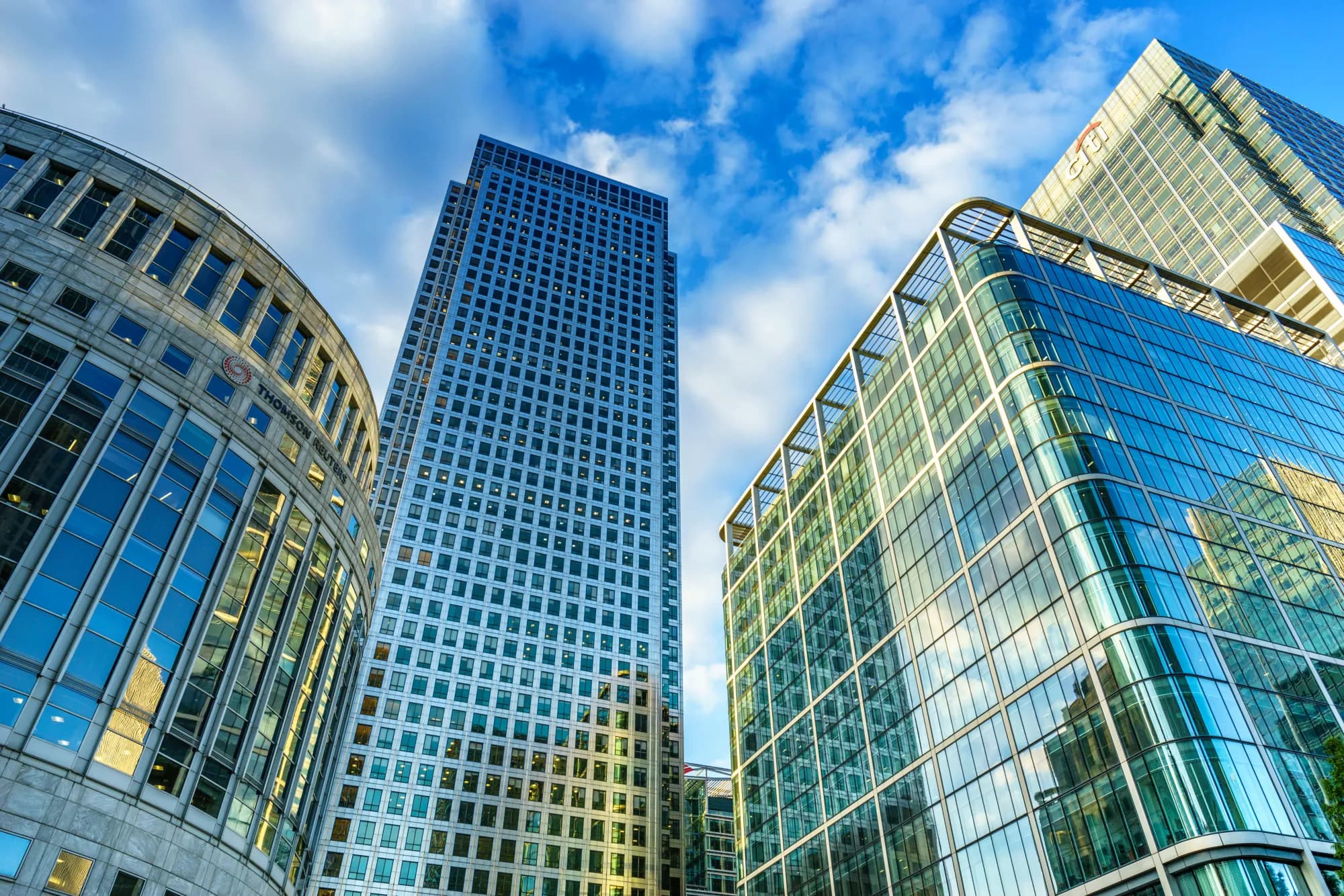 Canary Wharf London skyline with tall office towers and financial district buildings along the River Thames