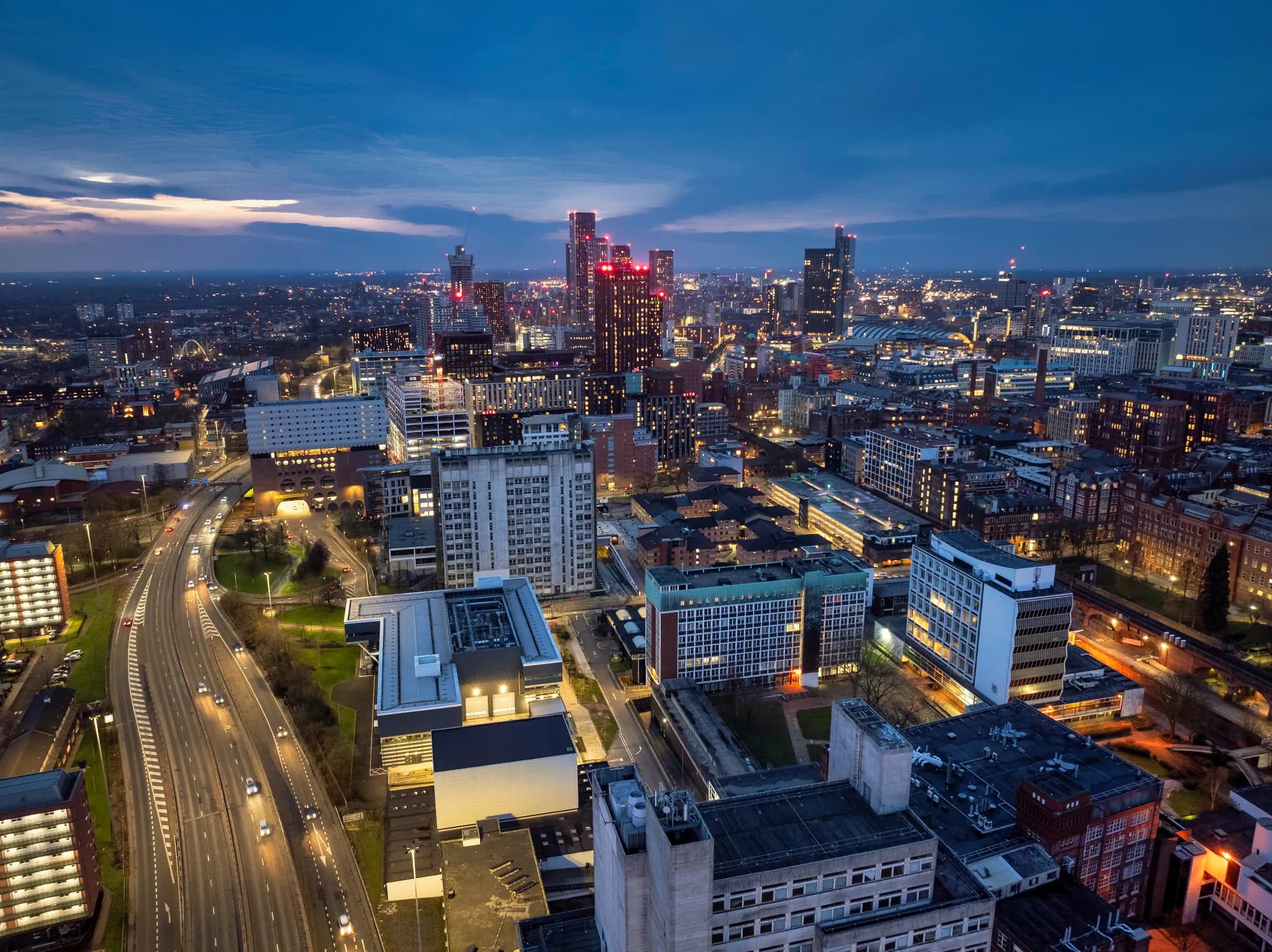 Aerial view of the Victoria North urban regeneration project area with construction and mixed-use development in Manchester, UK